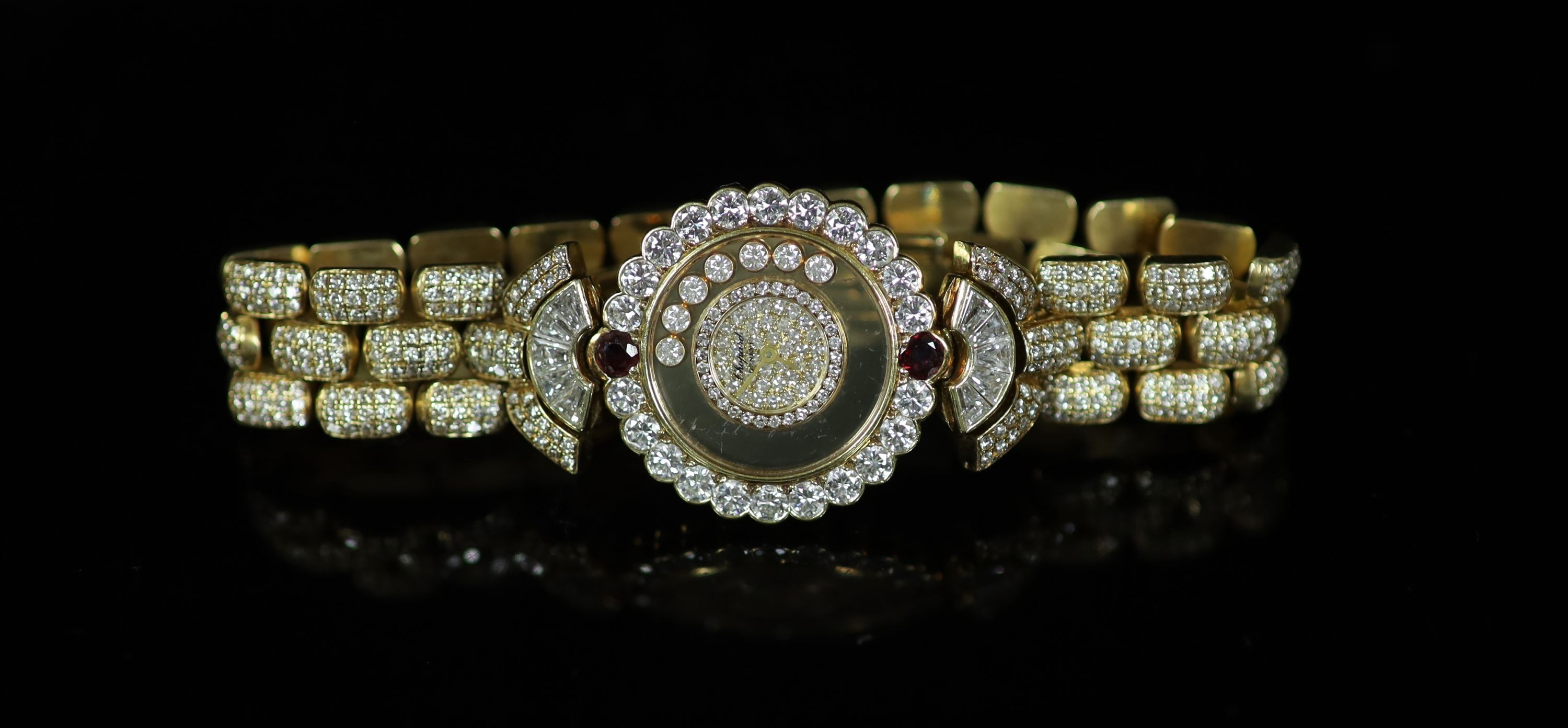 A lady's Chopard 'Happy Diamonds' 18ct gold, ruby and diamond encrusted dress wrist watch